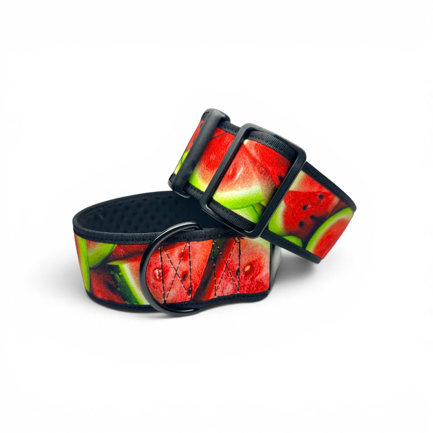 A dog collar with a vibrant watermelon slice print, featuring red flesh, green rinds, and black hardware, displayed on a clean white background.
